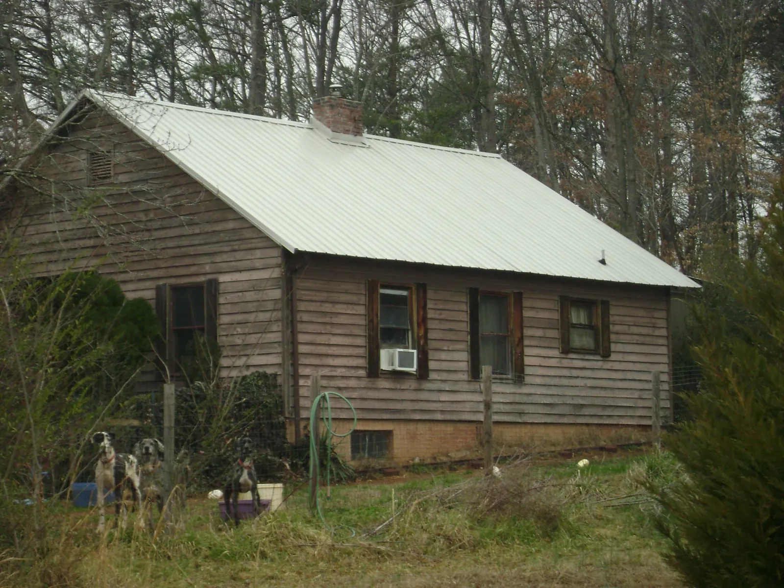 White metal roof on an old wood sided farmhouse, from a Metal Roof Installation job in Saco